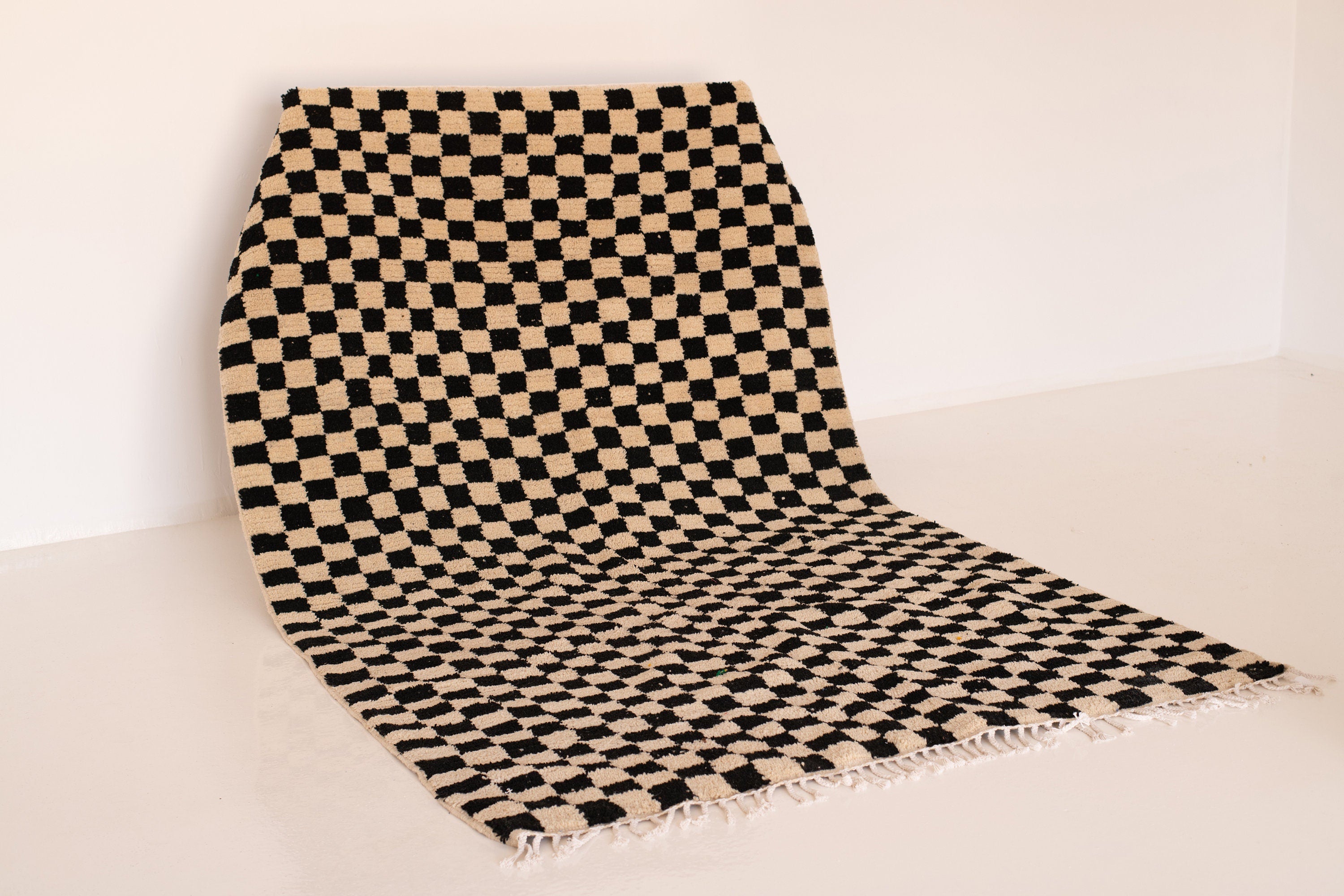 Checkered black and beige rug, perfect for modern home decor and stylish interiors.