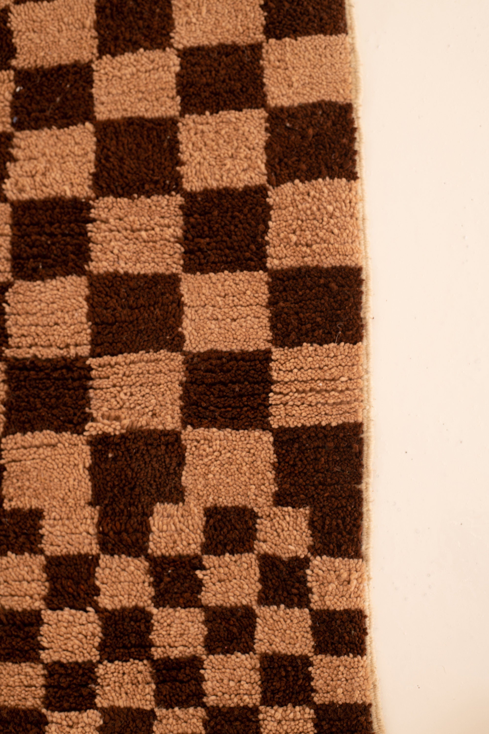 Checkered brown and beige rug, perfect for modern home decor and cozy interiors.