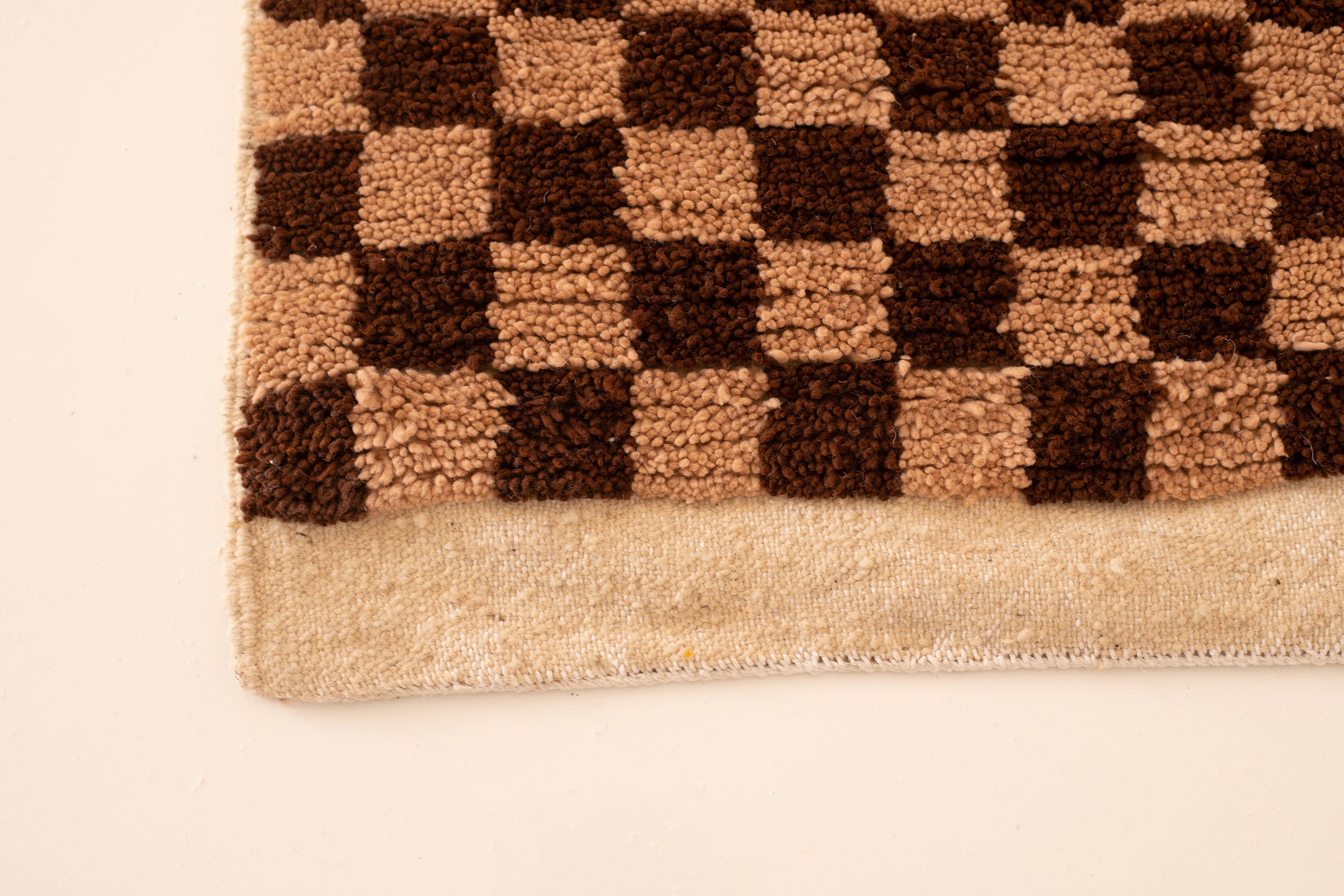 Checkered rug in earthy tones, perfect for adding warmth to any space.