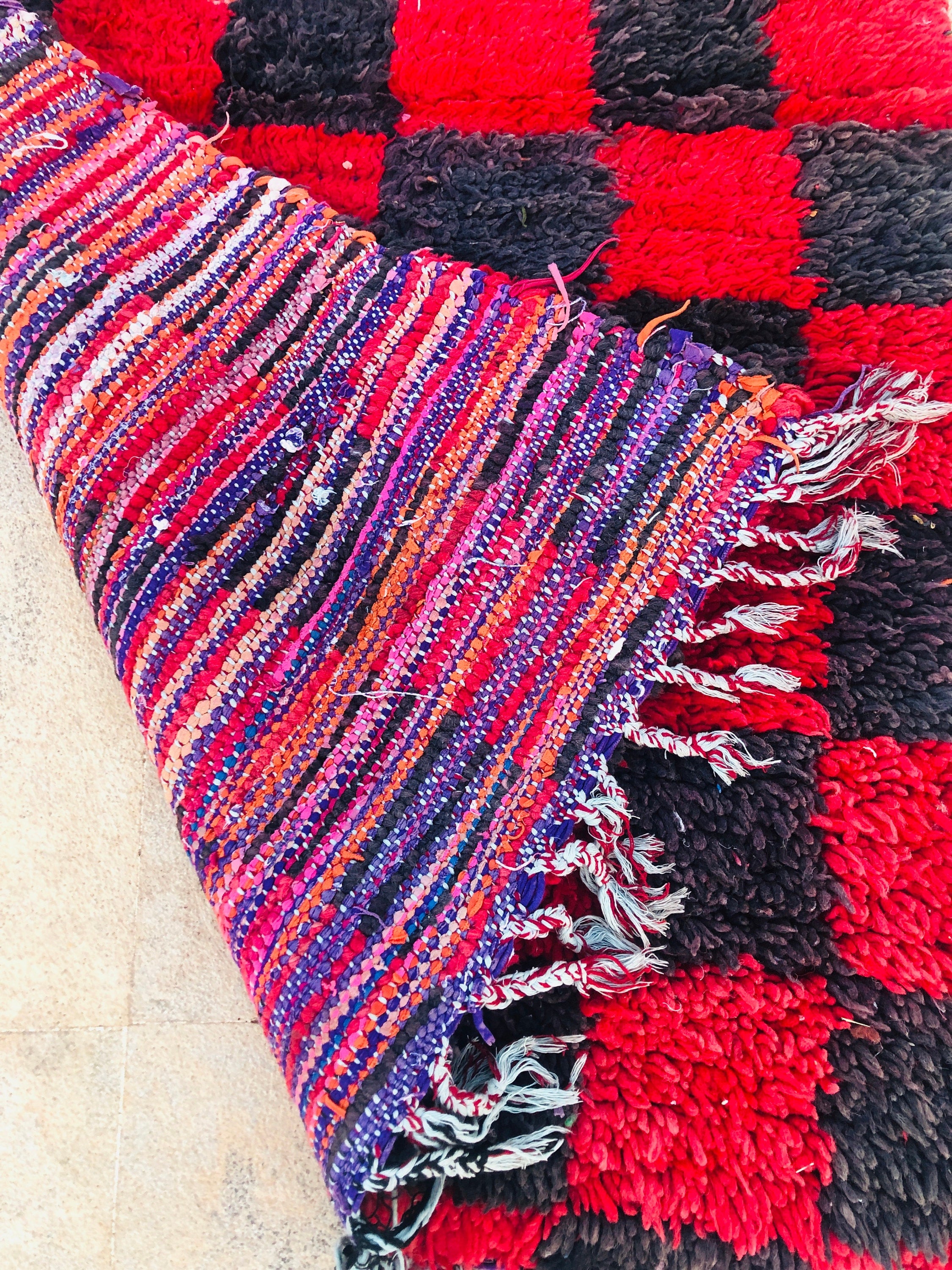 Colorful woven rug with intricate patterns and vibrant hues, perfect for home decor.