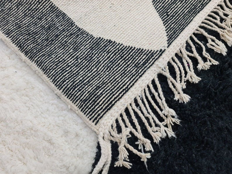 woven rug with black and white patterns