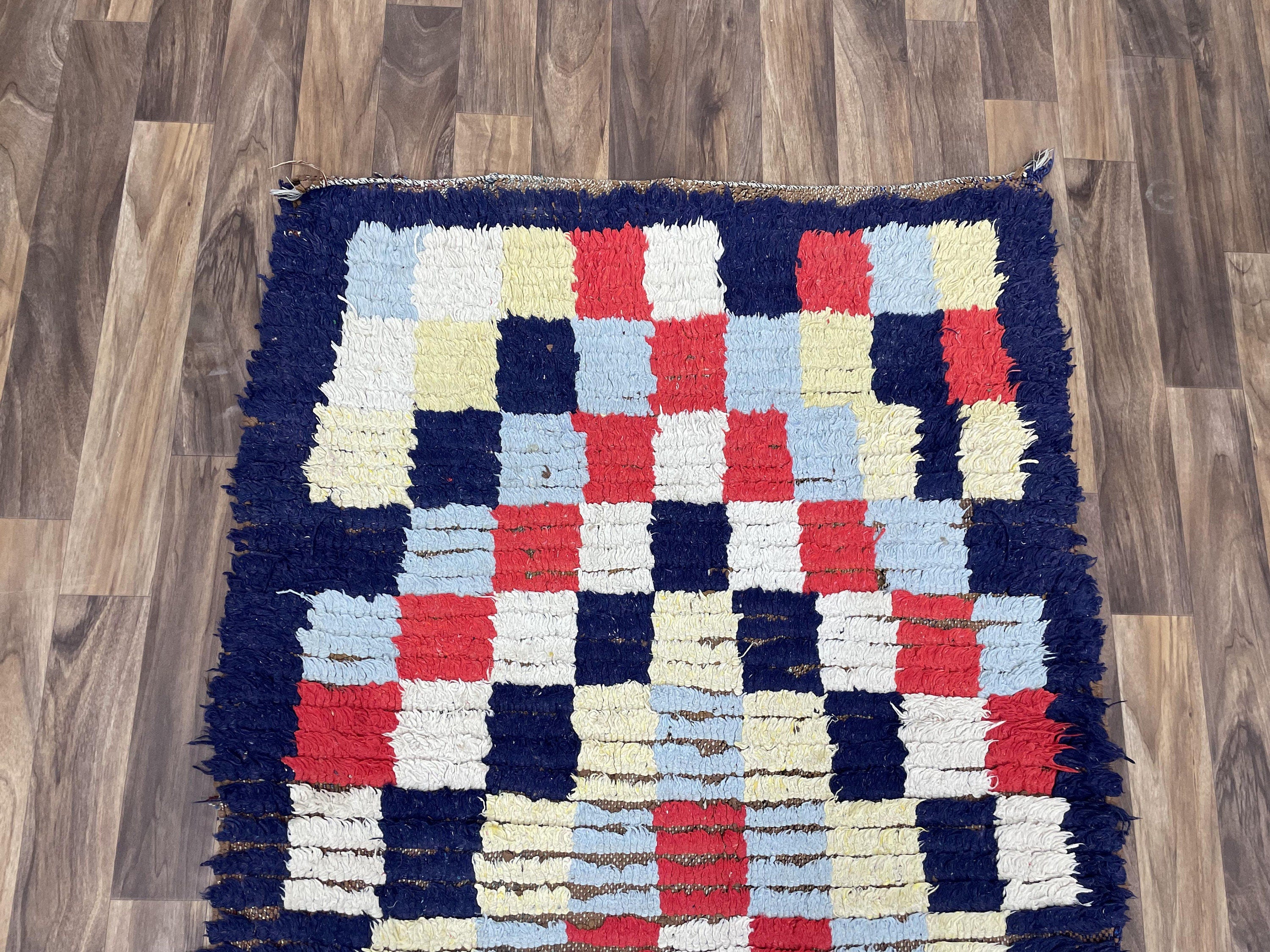 Colorful handmade rug with a geometric pattern, perfect for enhancing home decor.