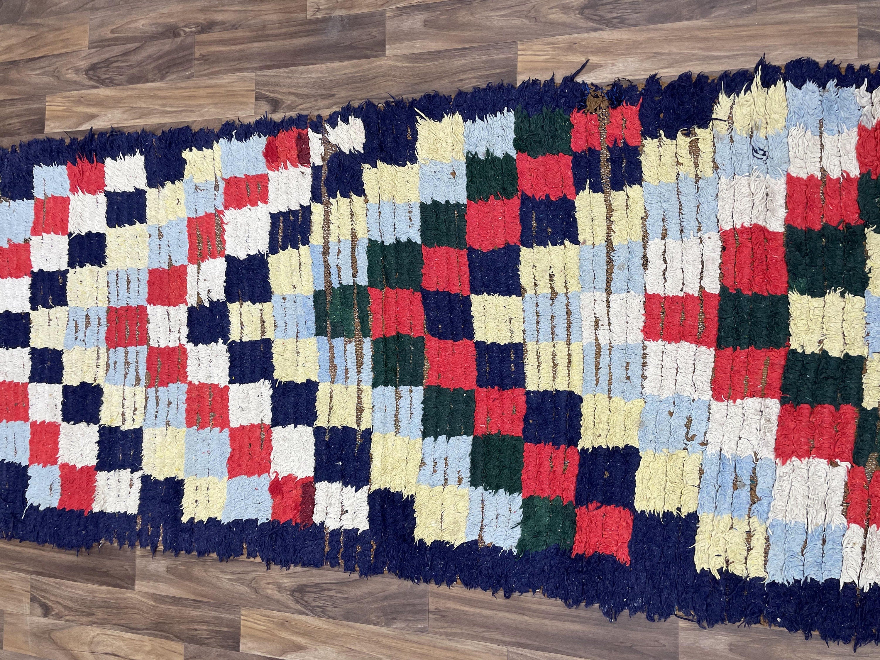 Colorful woven rug featuring a checkered pattern in vibrant hues for stylish home decor.