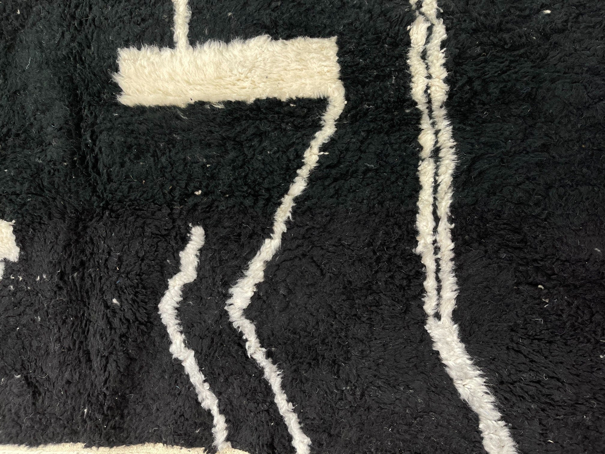 black and white textured rug with abstract design