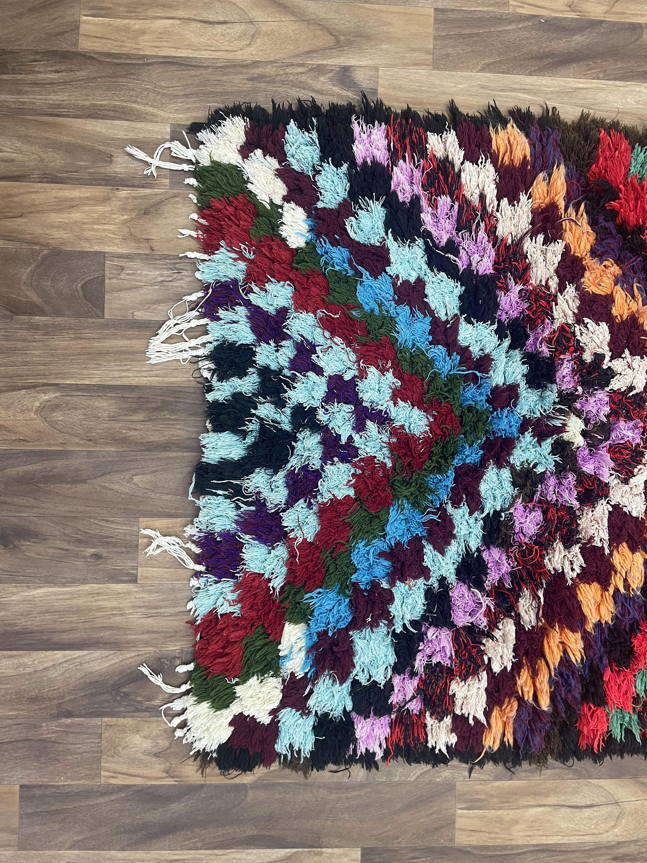 Colorful handmade rug with textured pattern, perfect for brightening any space.