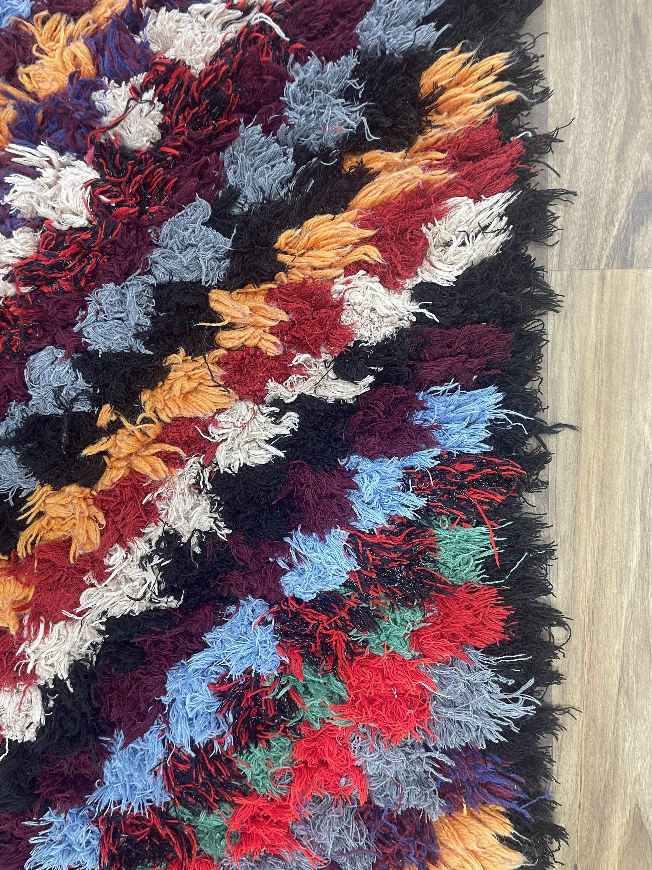 Colorful shag rug with vibrant patterns, perfect for adding warmth to any space.