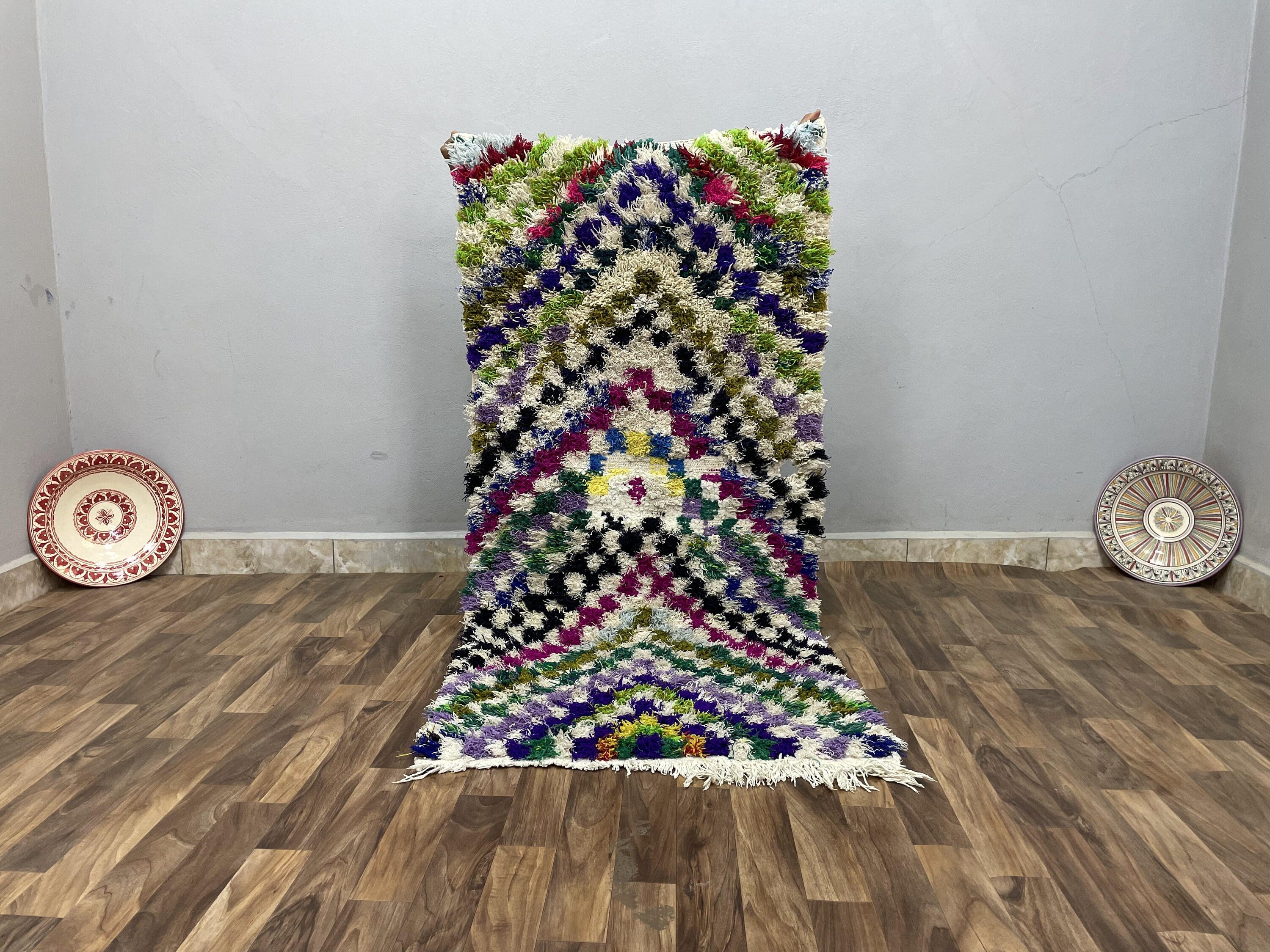 Colorful handwoven rug with intricate patterns, perfect for home decor and warmth.