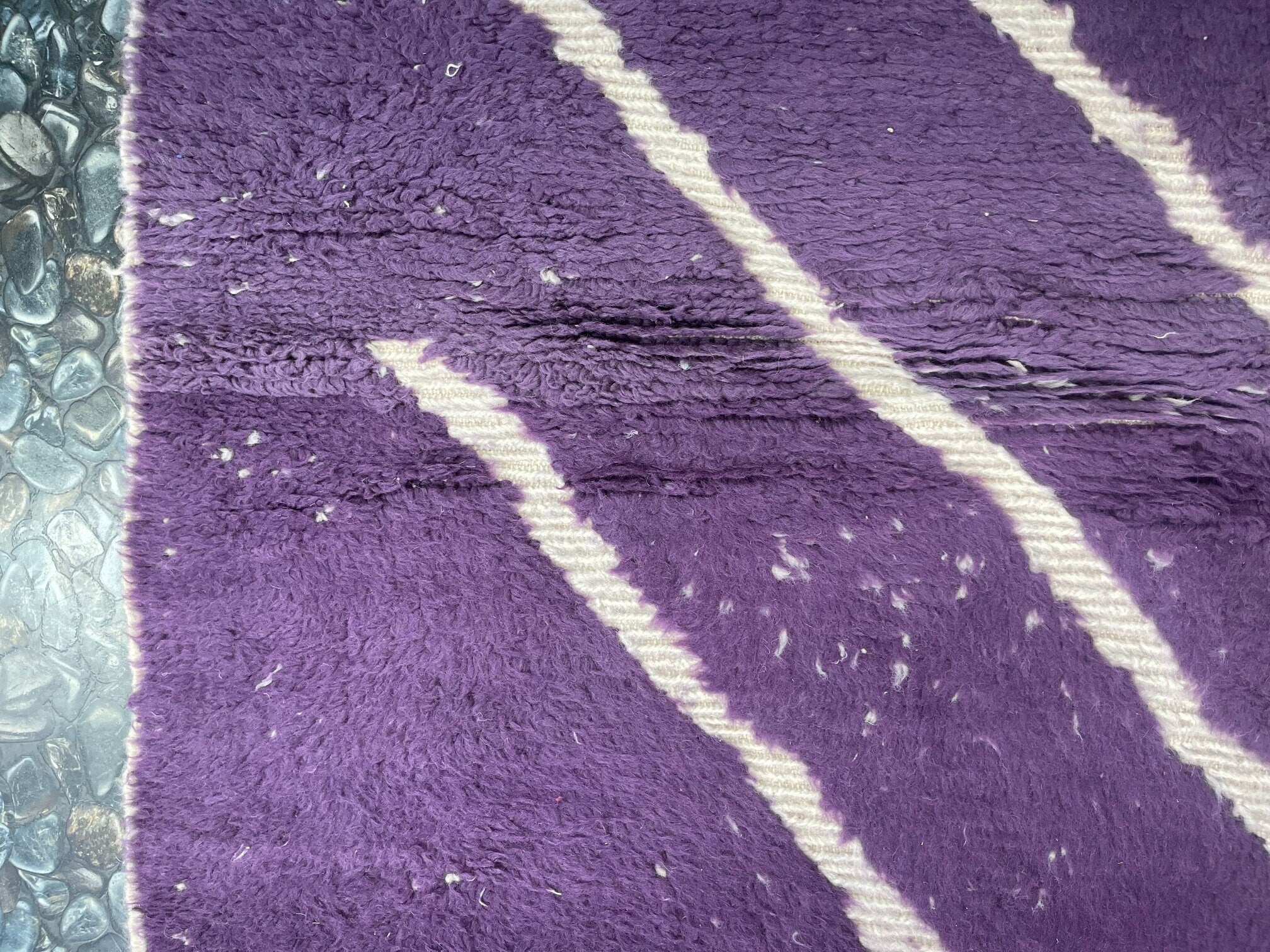 purple textured rug with white stripes design