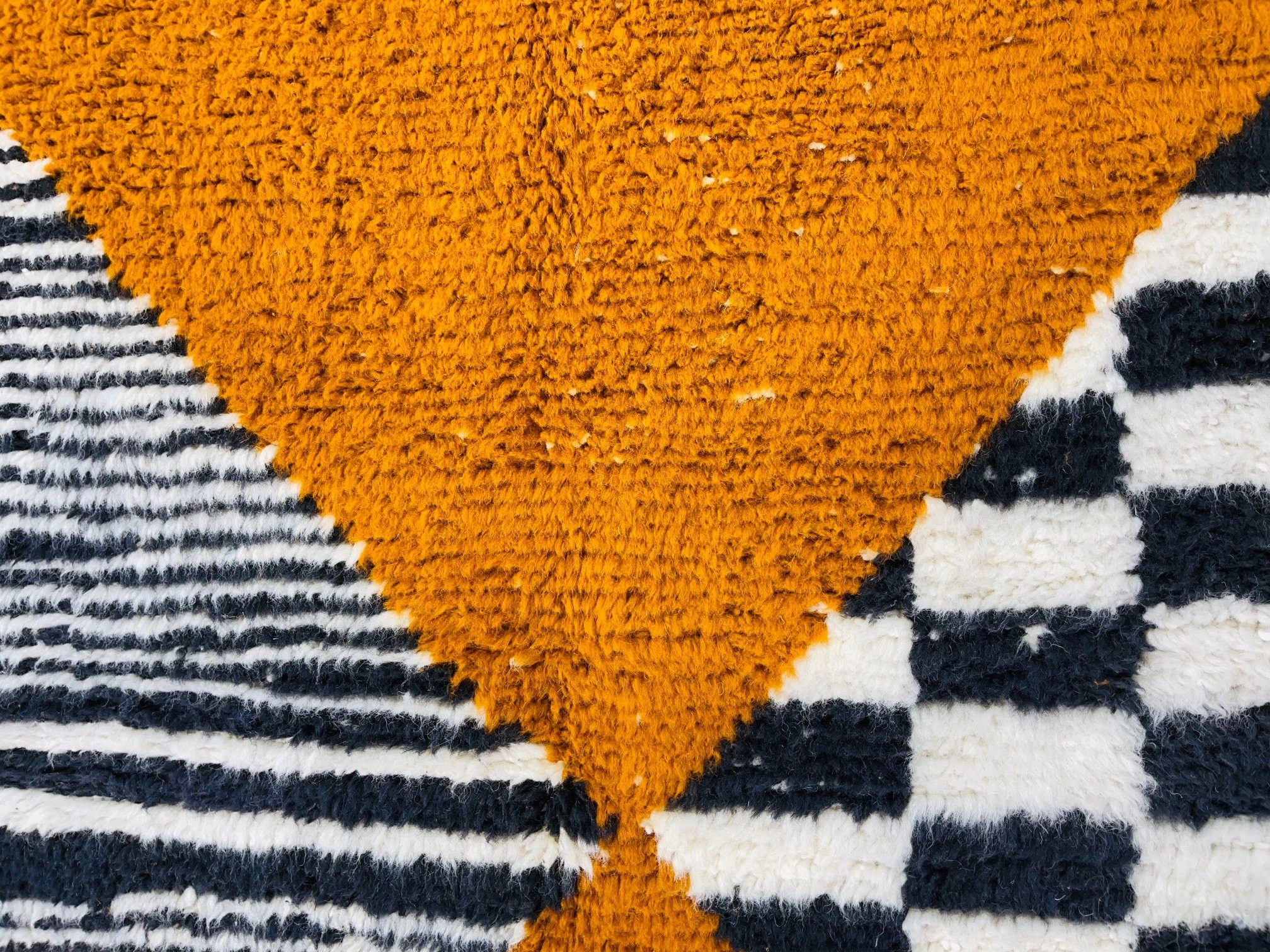 orange and black geometric patterned area rug