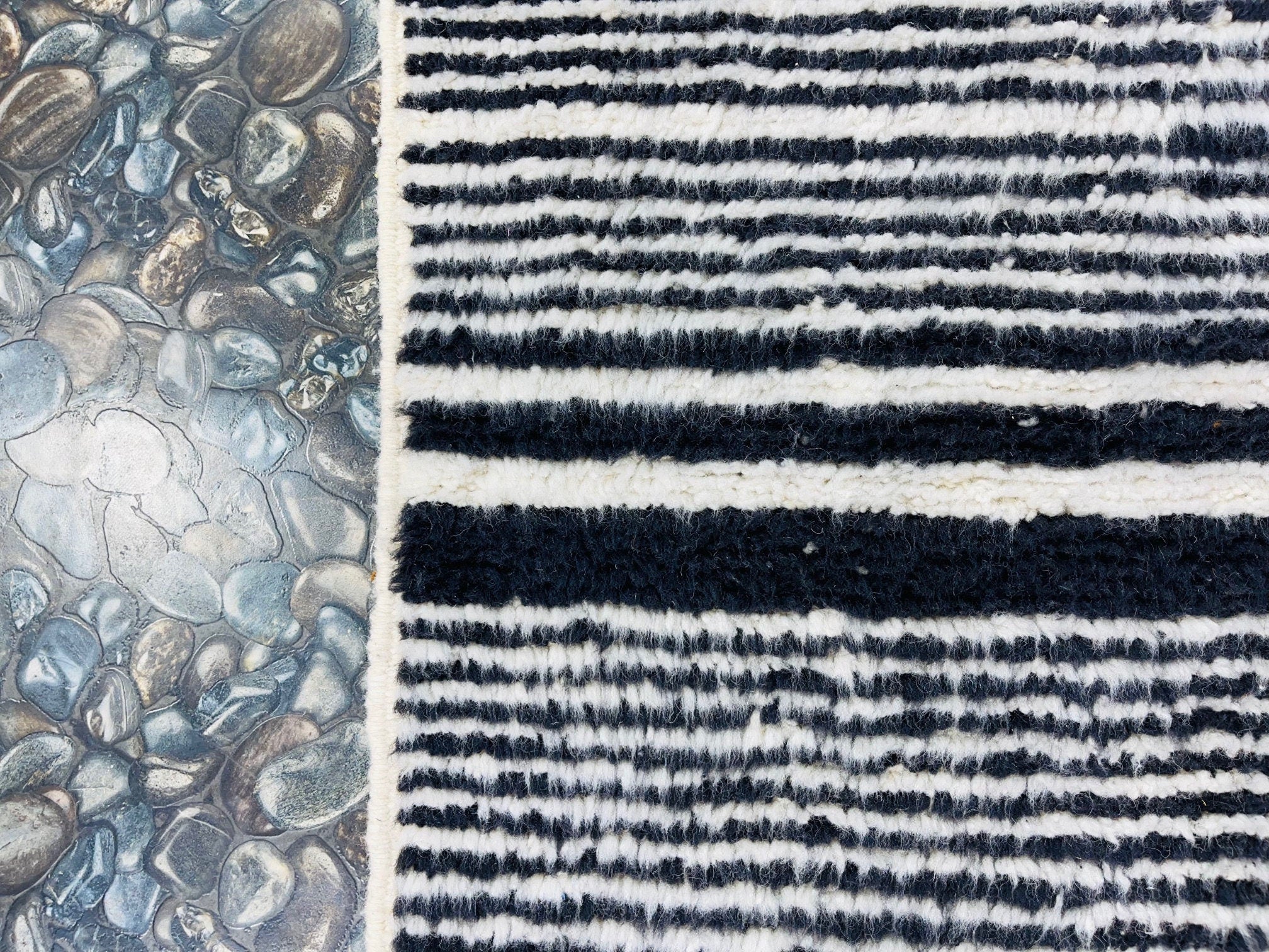 striped rug and pebbled surface side by side