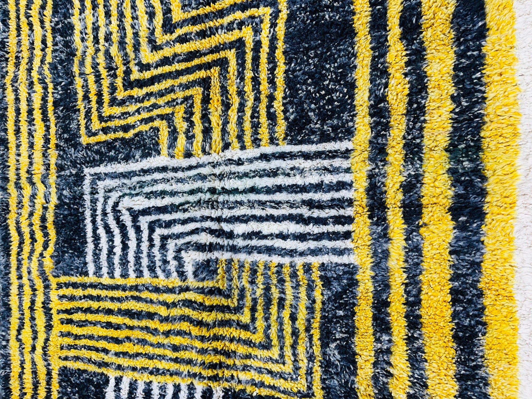 yellow and black geometric patterned area rug