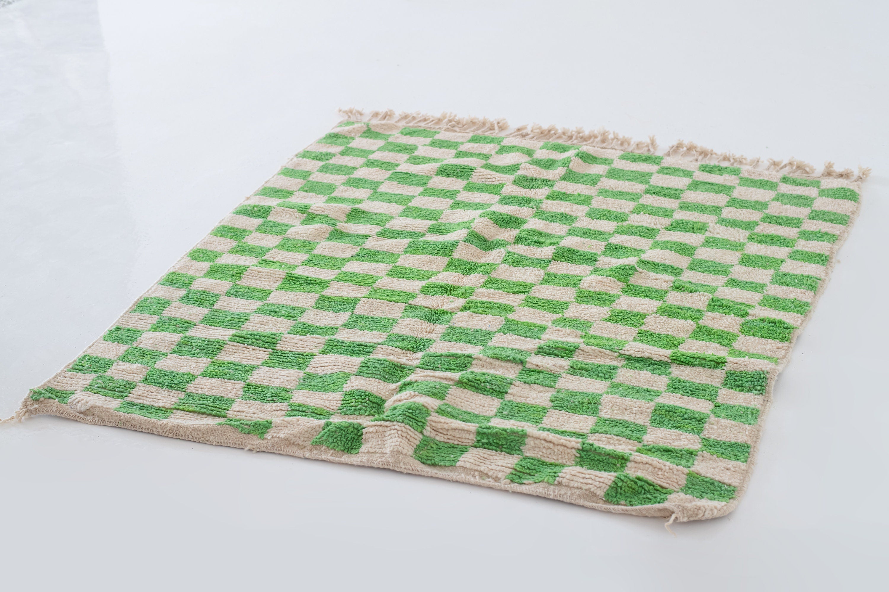 green and white checkered rug on floor