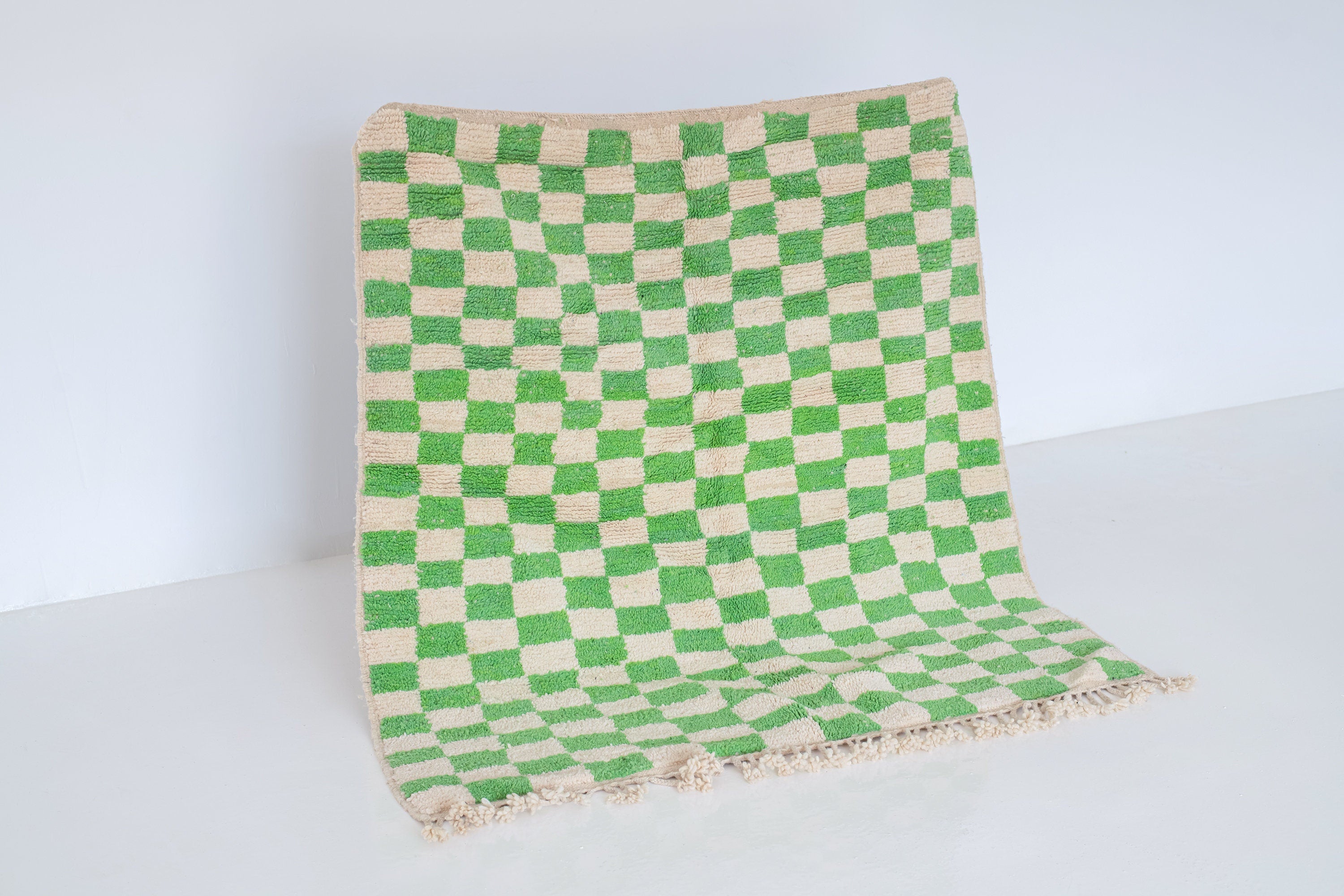 green and beige checkered decorative woven rug