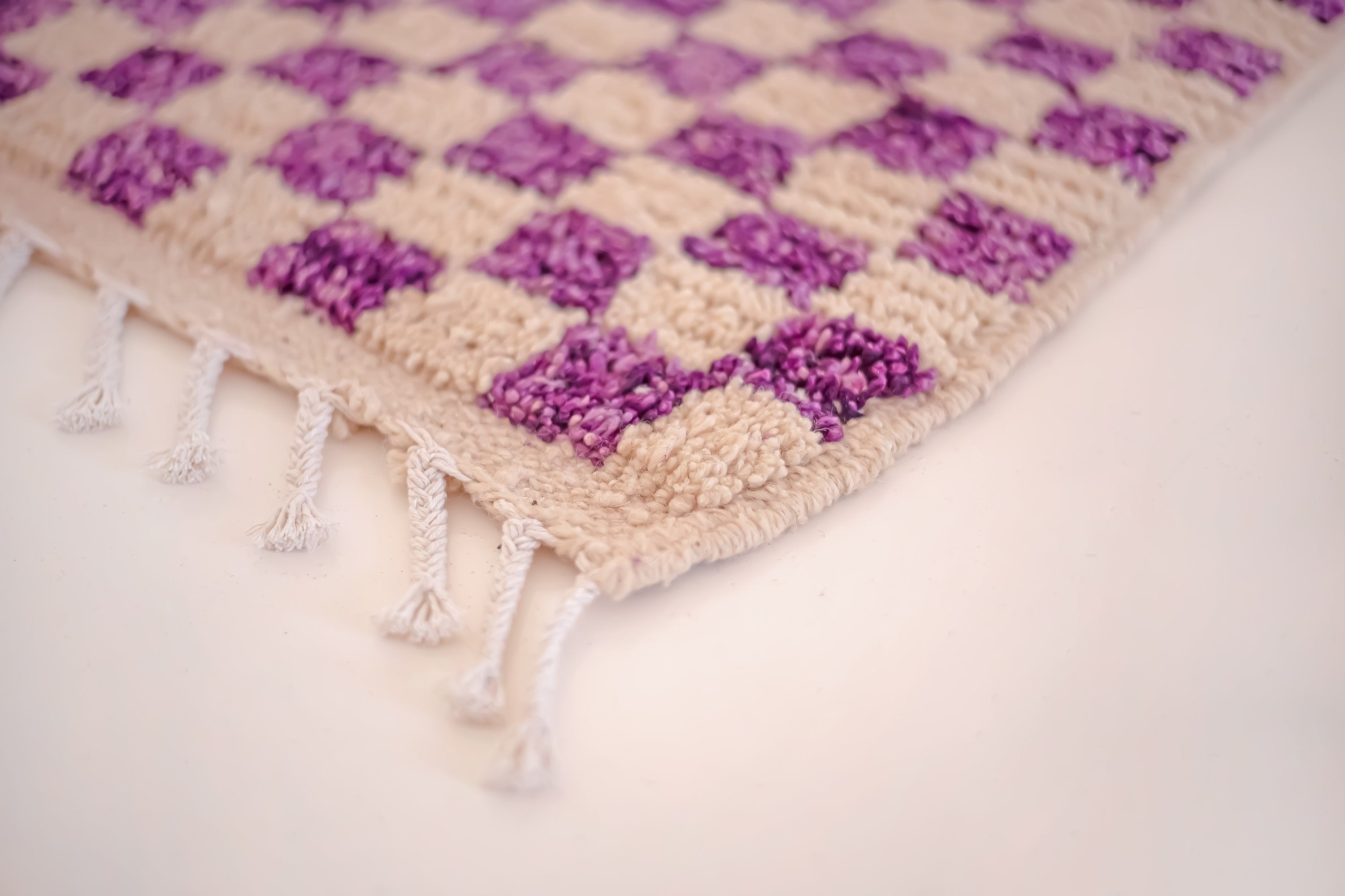 purple and beige decorative rug with fringes