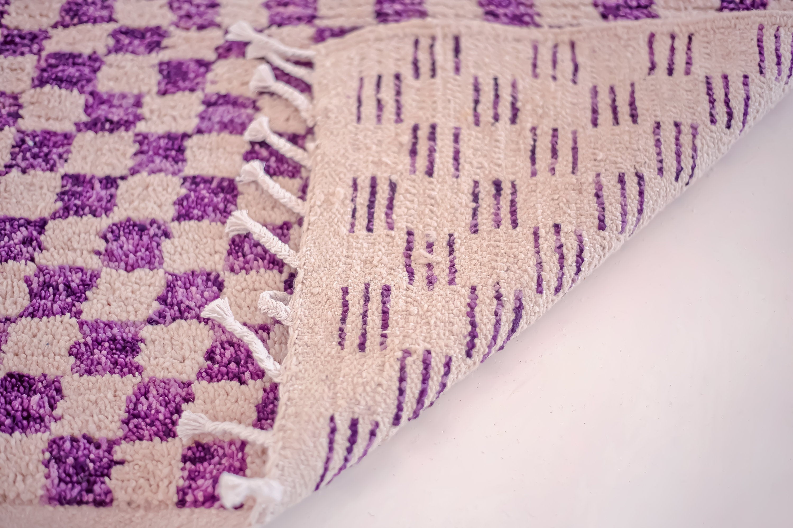 purple and beige patterned area rug closeup