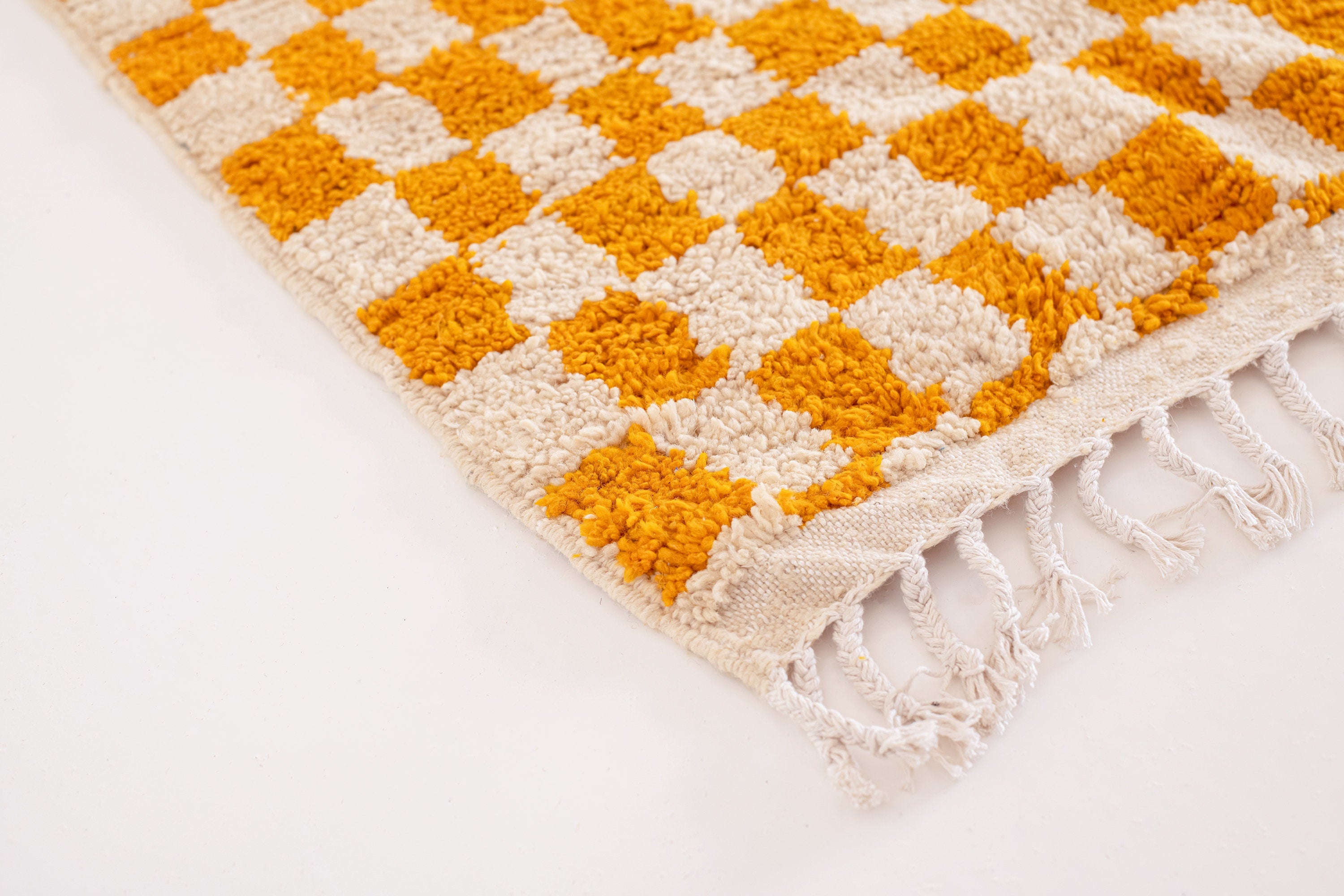 Orange and cream checkered woven area rug