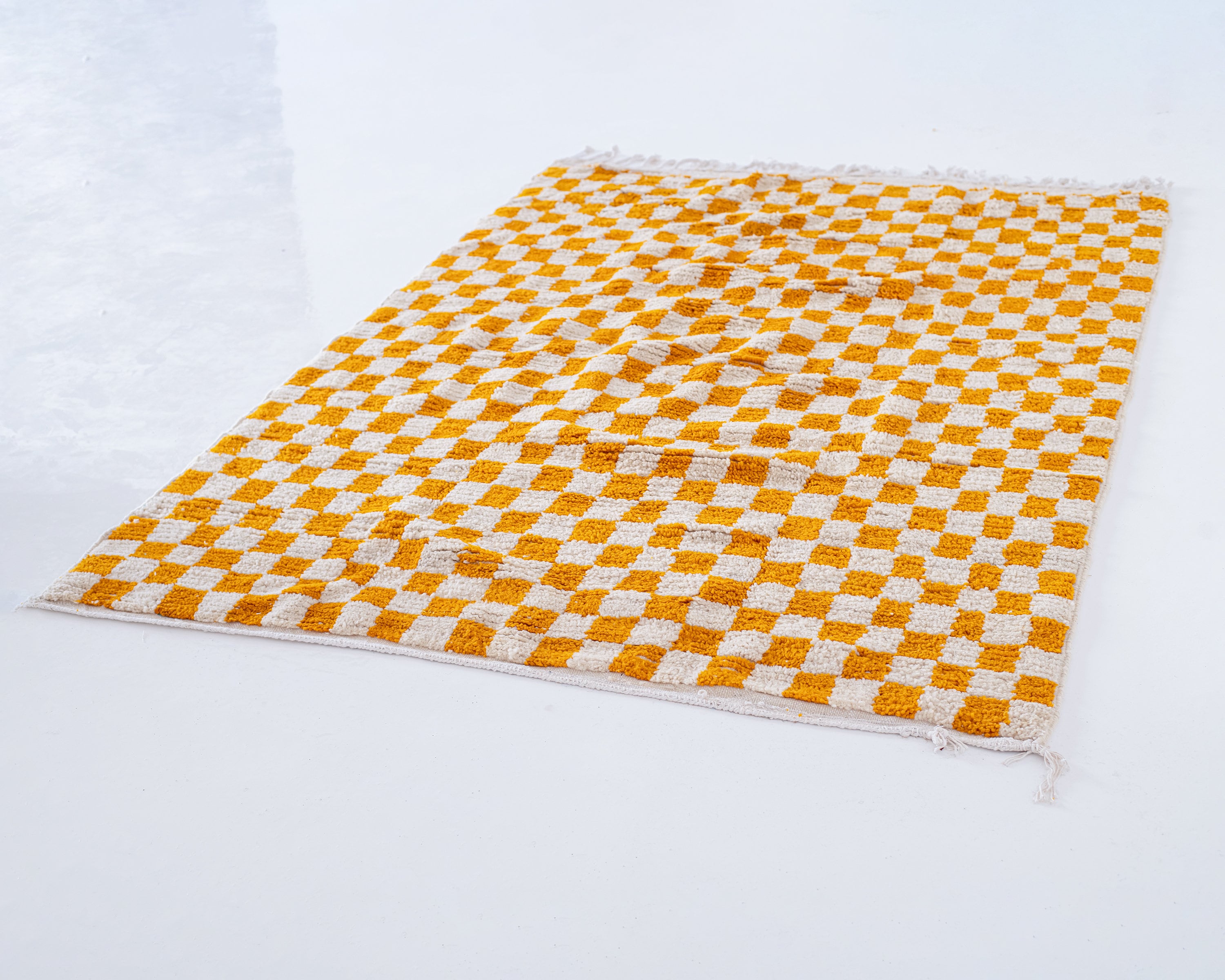 Orange and white checkered rug on floor