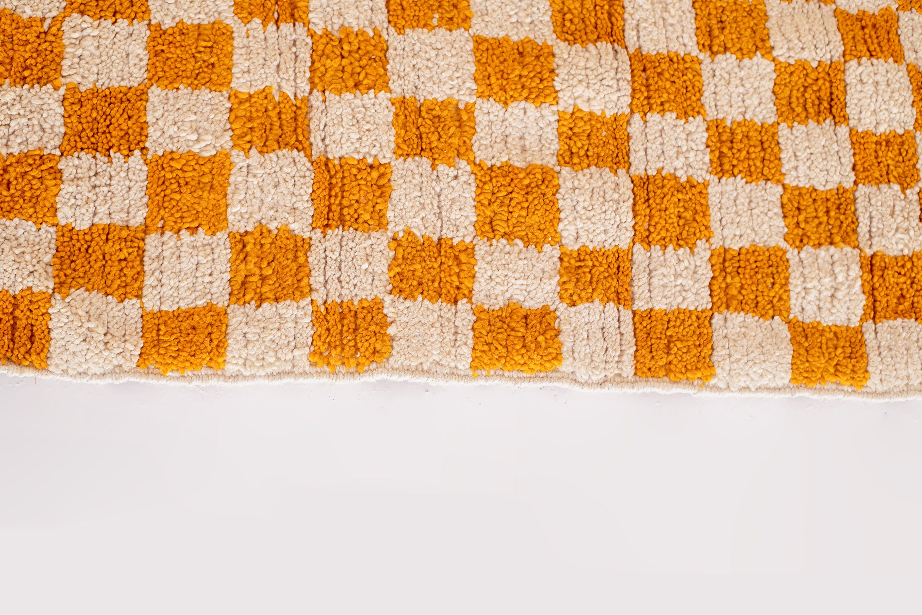 orange and white checkered textured area rug