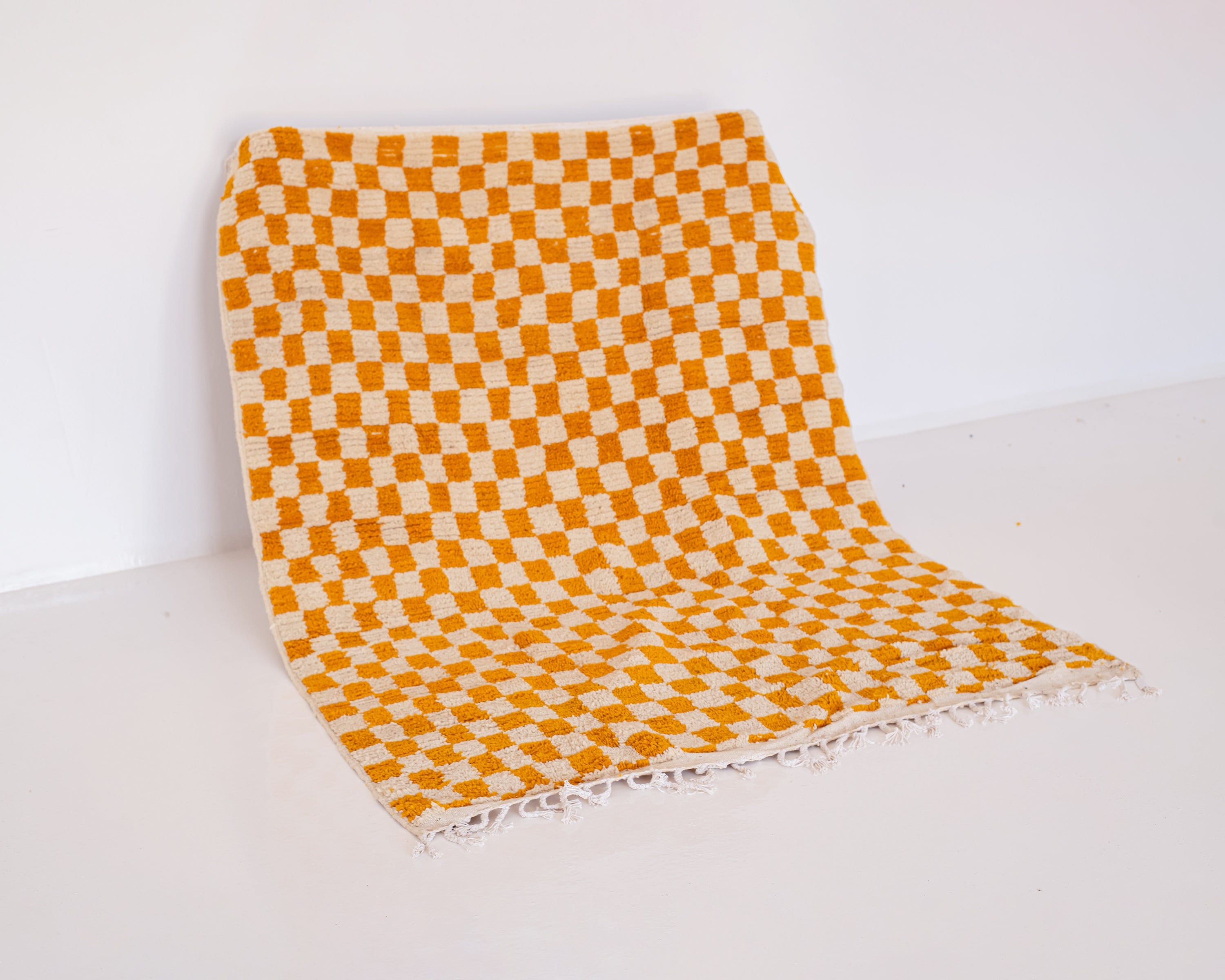 orange and cream checkered pattern woven rug