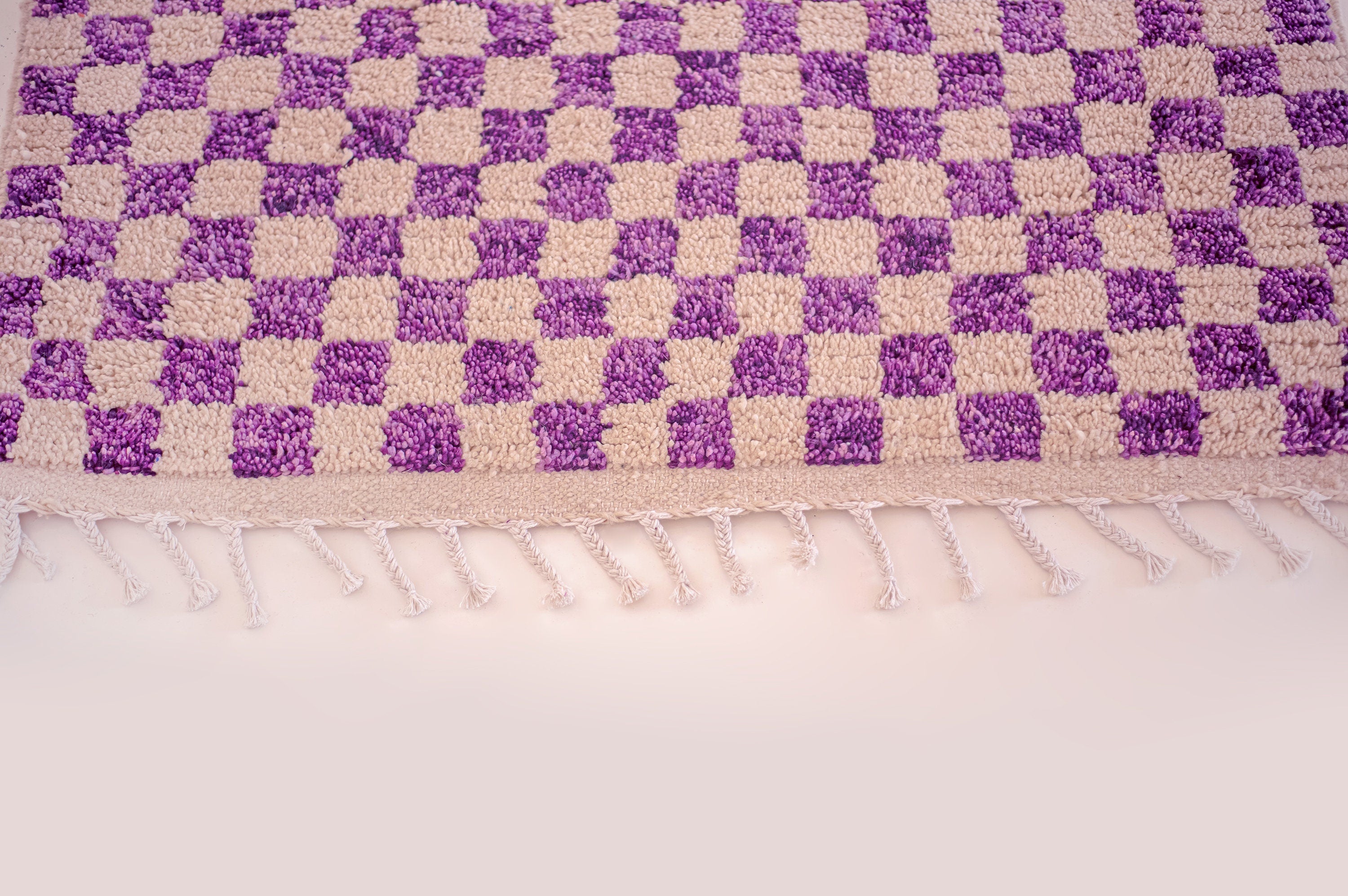 purple and cream checkered patterned decorative rug