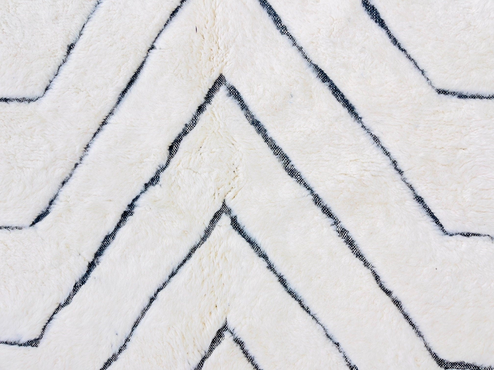 white shaggy rug with black zigzag pattern