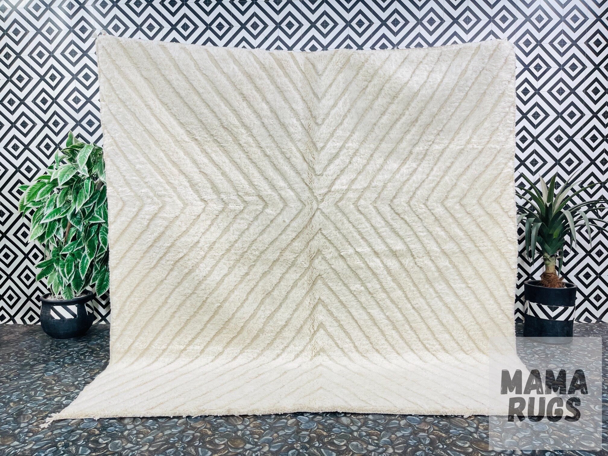 cream geometric rug against patterned black background