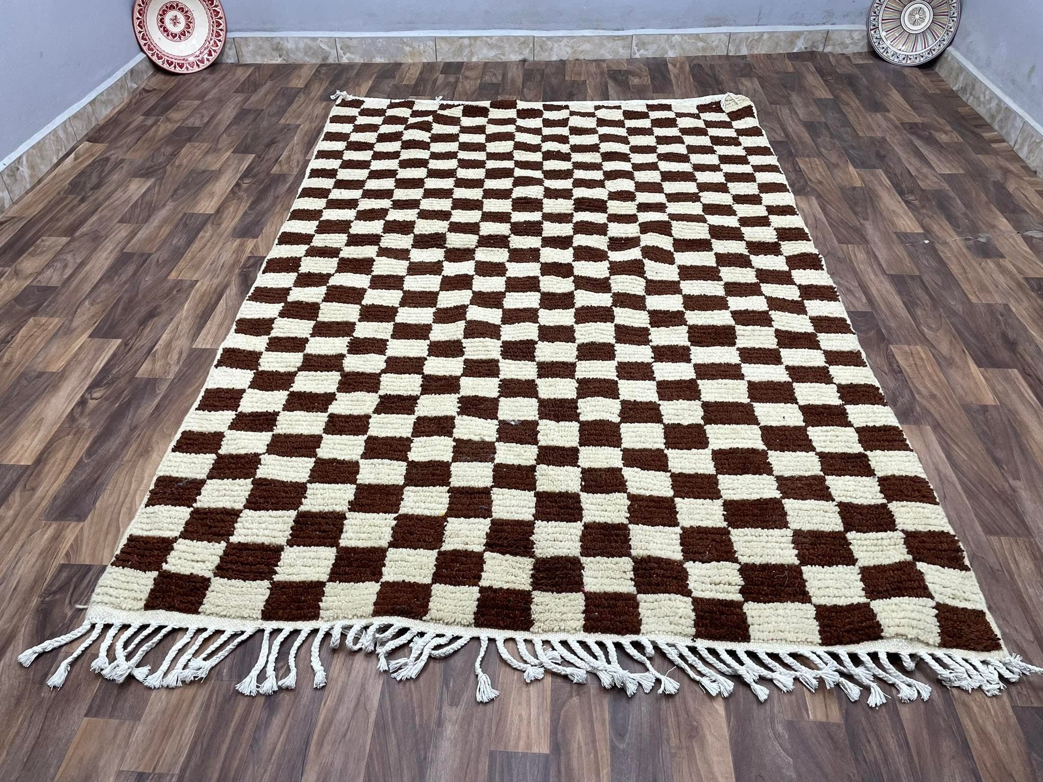 Brown and cream checkered rug with fringes, perfect for modern home decor.