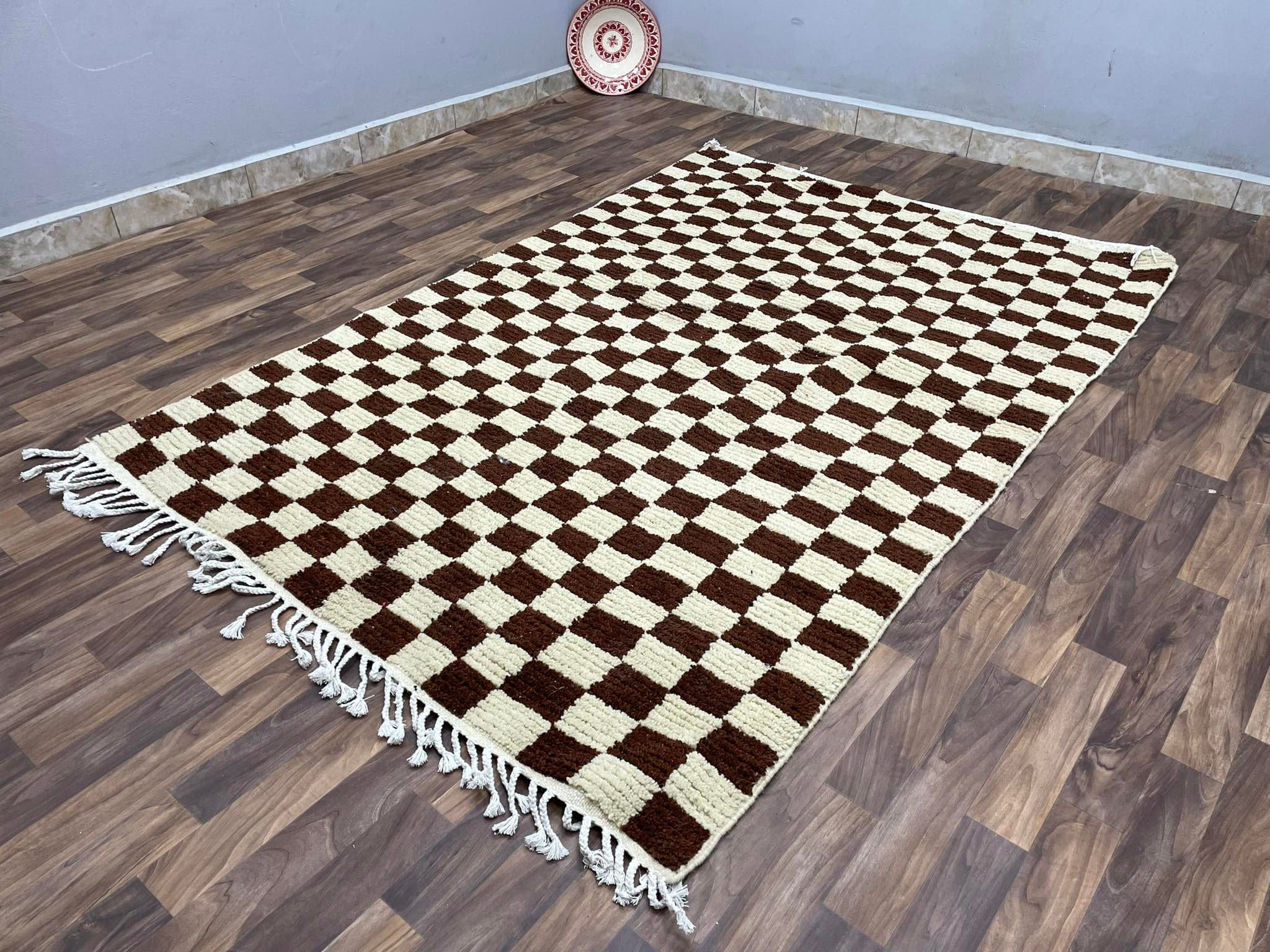 Handcrafted checkered area rug in brown and cream, perfect for stylish home decor.