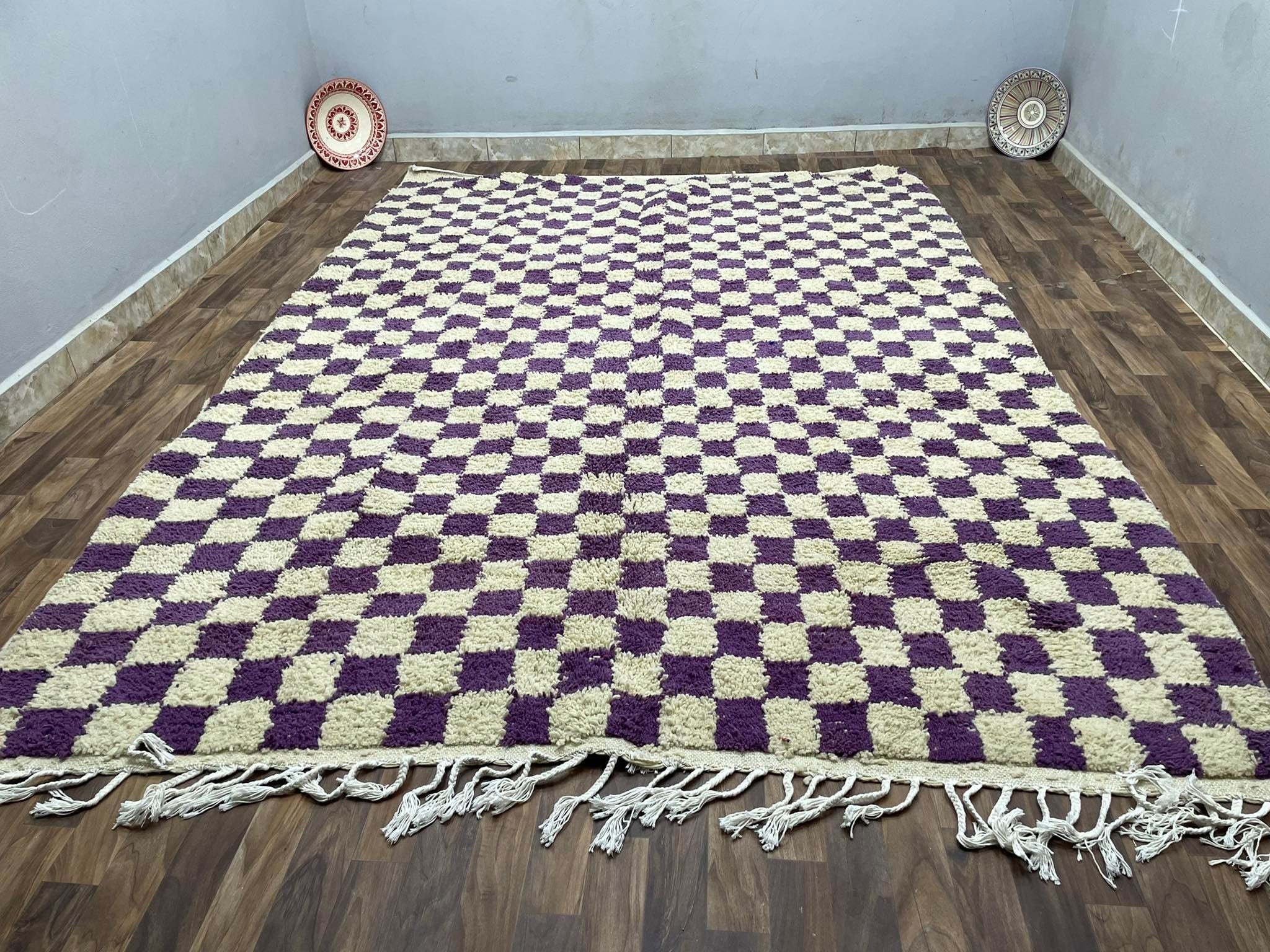 Soft checkered area rug in purple and cream, perfect for home decor.