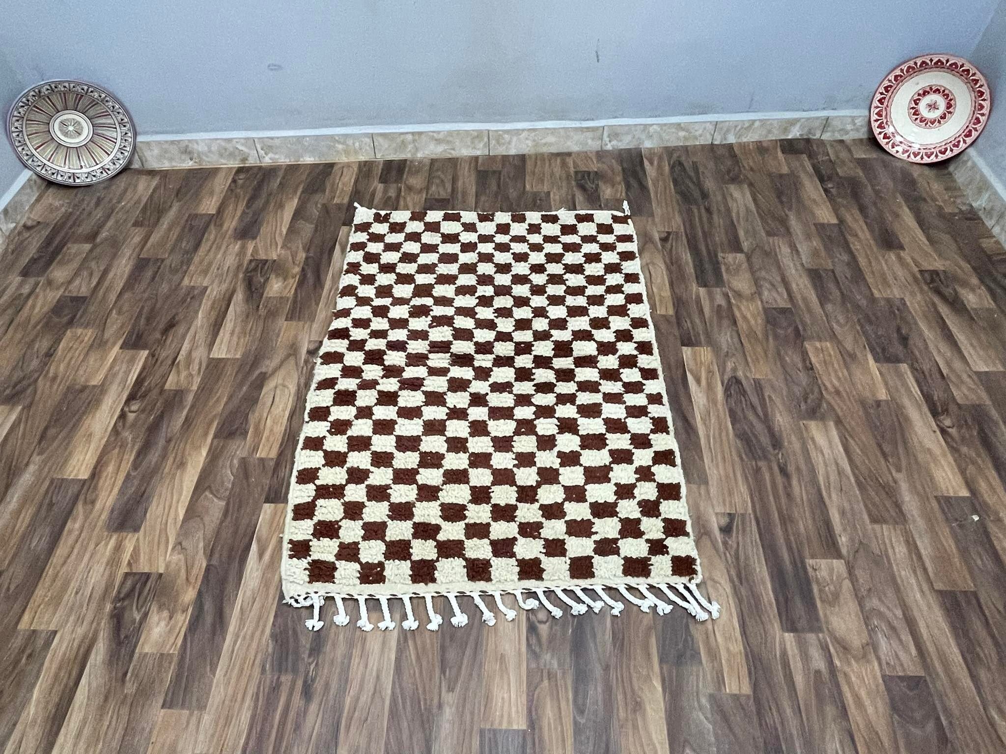 Handwoven checkered rug in earthy tones, perfect for enhancing any living space decor.