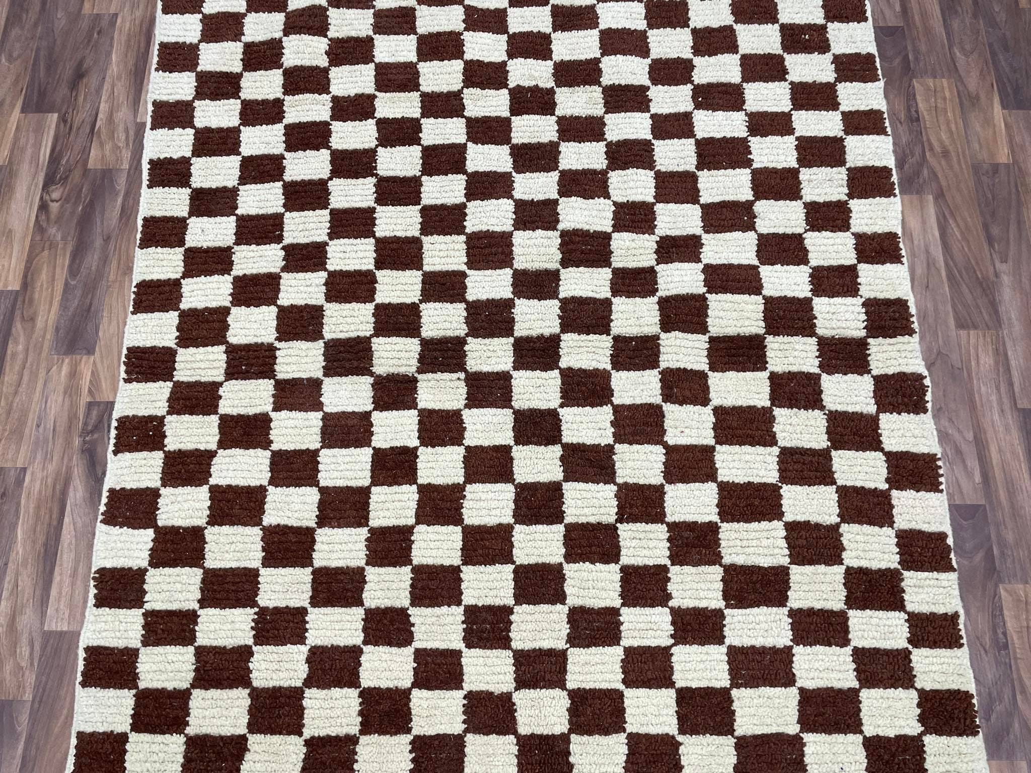 Brown and cream checkered rug, perfect for enhancing home décor and adding warmth.