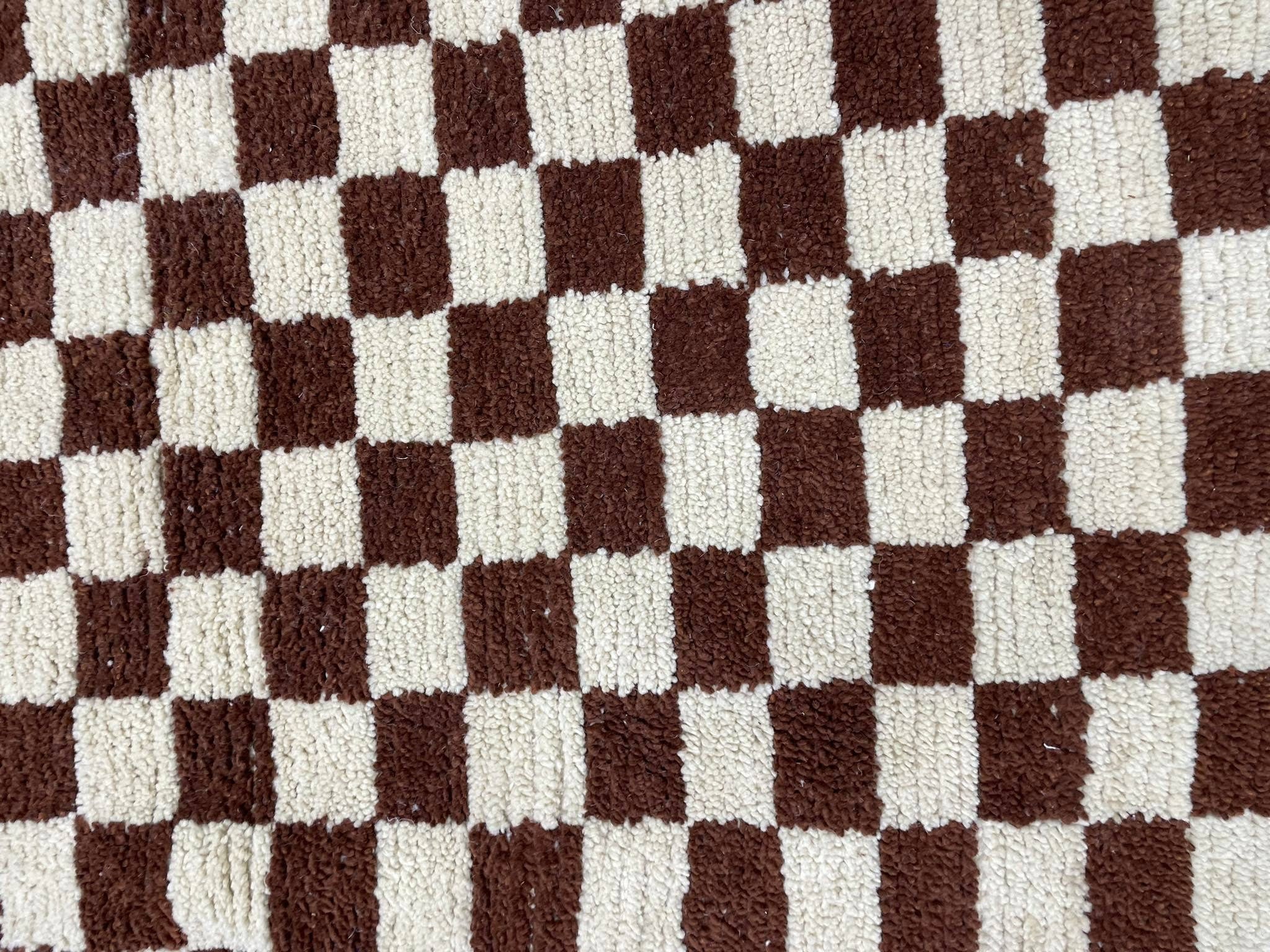 Brown and cream checkered plush rug, perfect for cozy home decor and comfort.