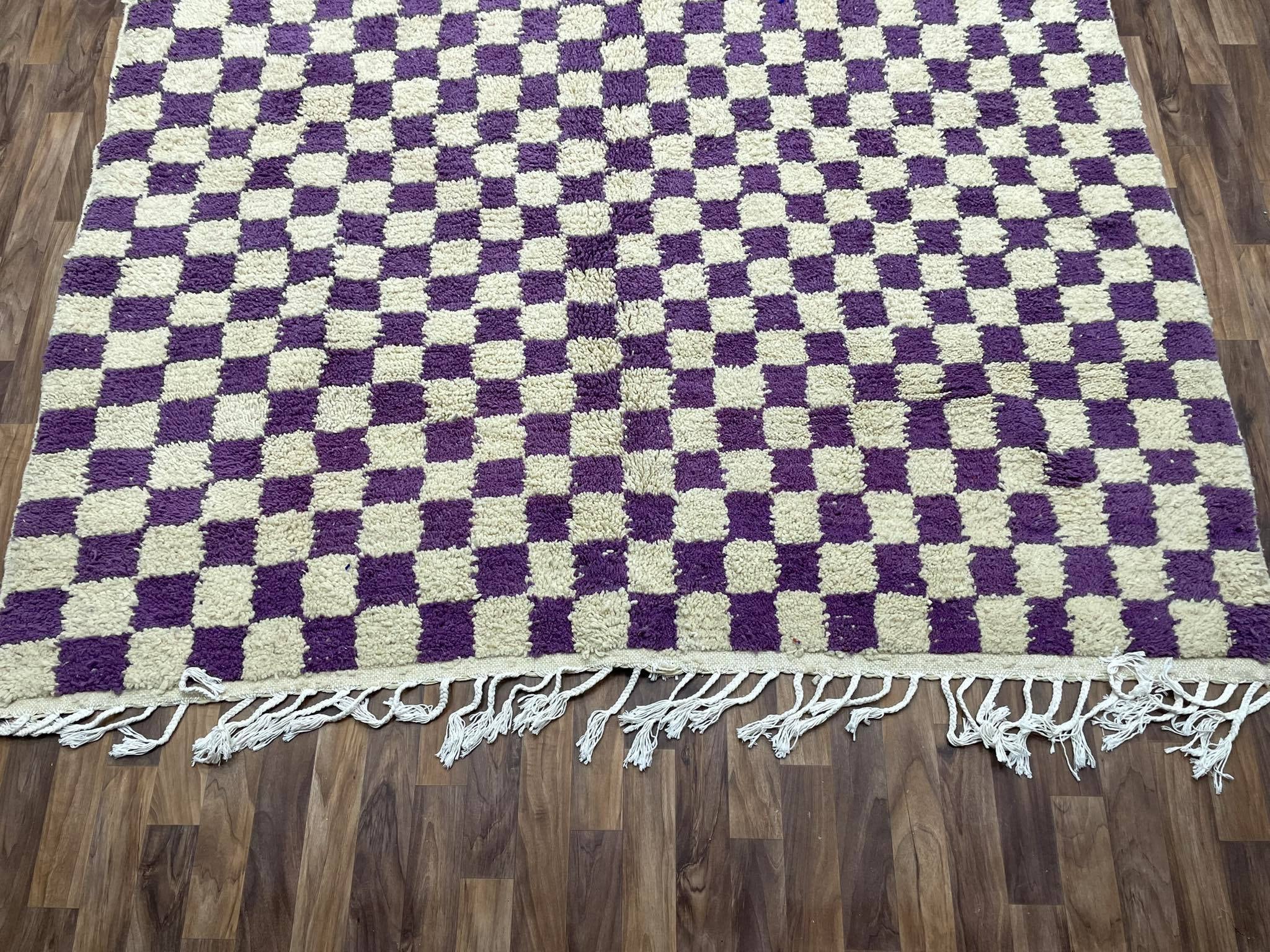 Purple and cream checkered rug with fringes, perfect for stylish home decor.