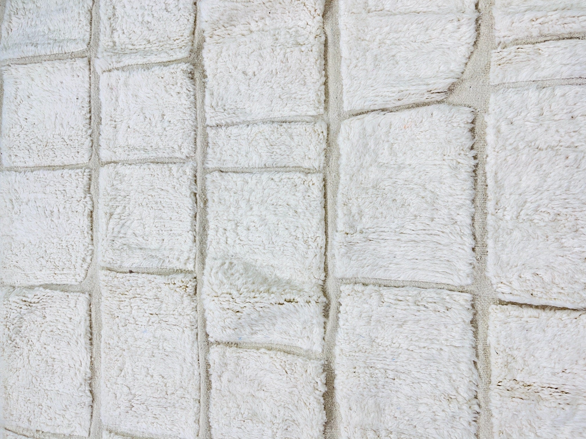 textured white fabric with square patterns closeup