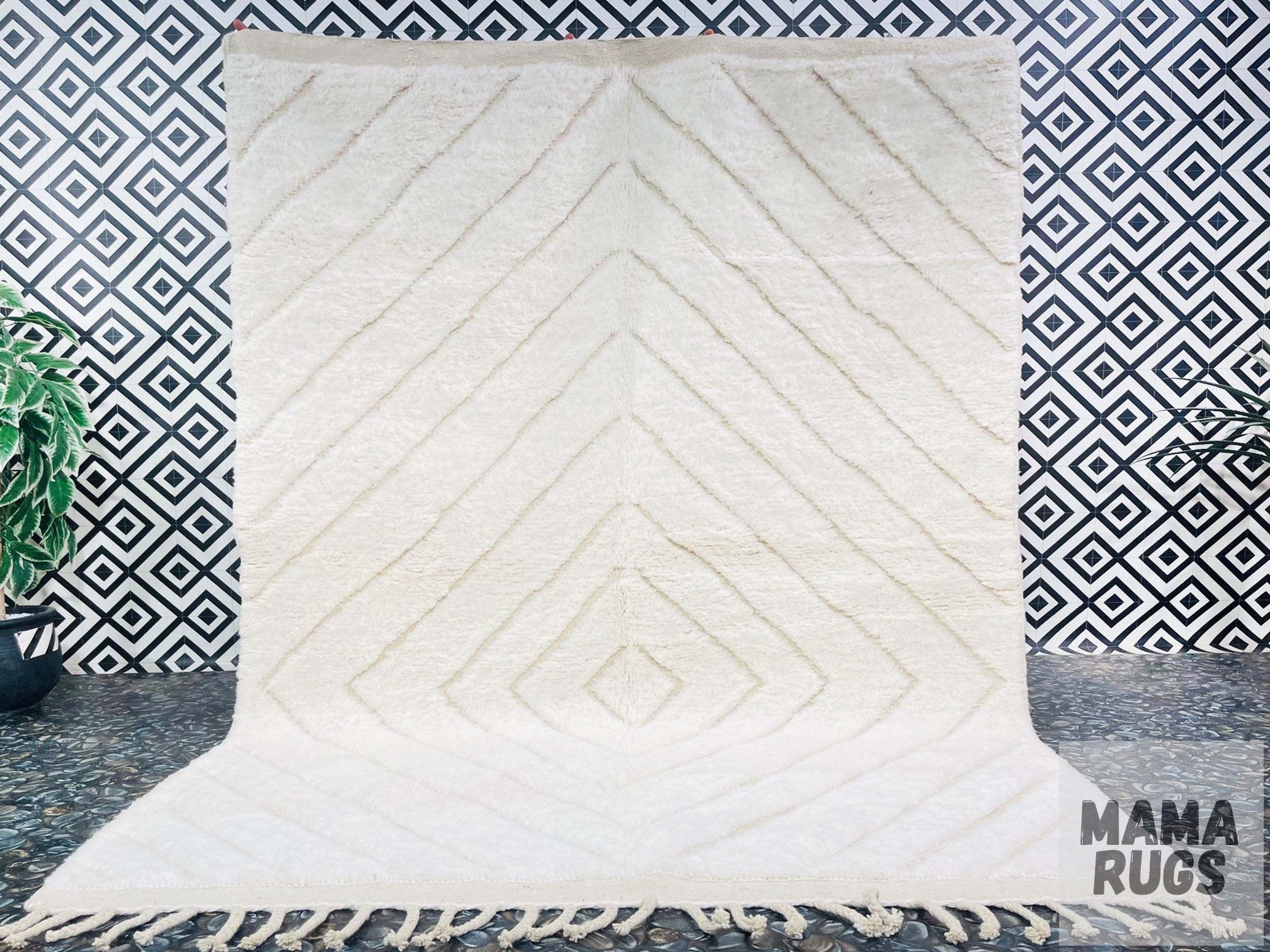 white geometric patterned rug against black background