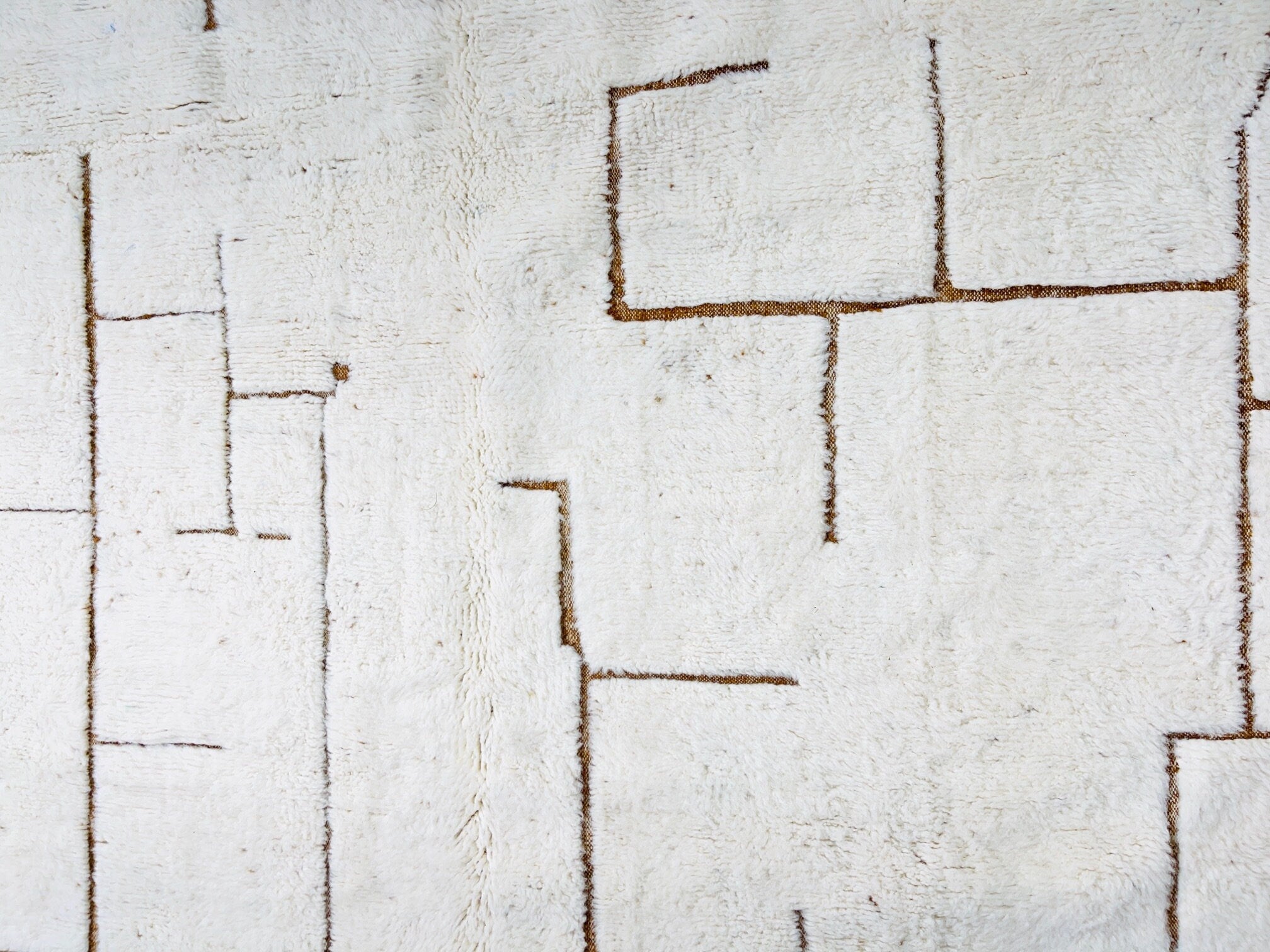 abstract white textured rug with brown lines