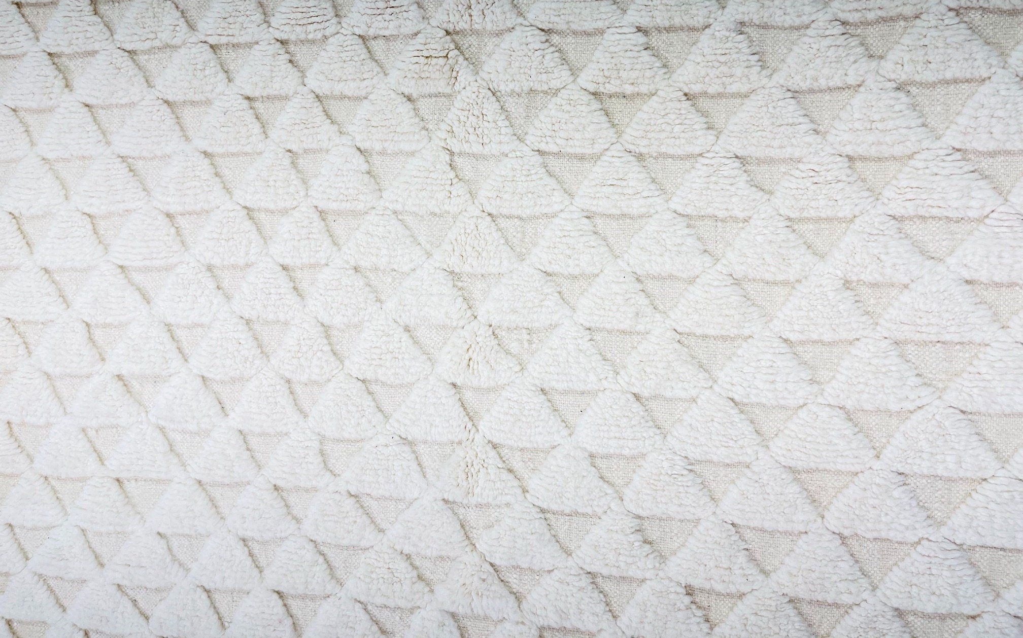 textured white fabric with triangular patterns design