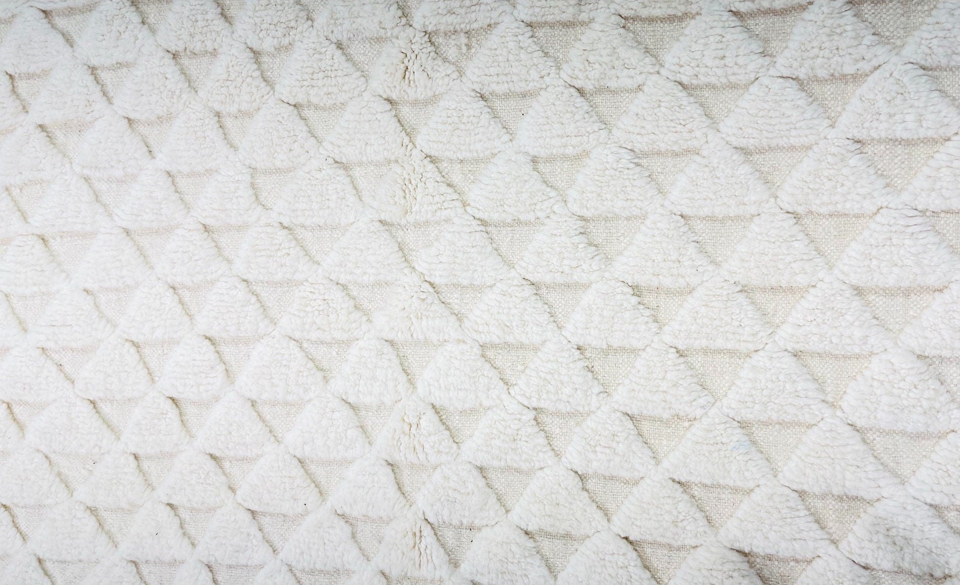 textured cream fabric with triangle pattern design