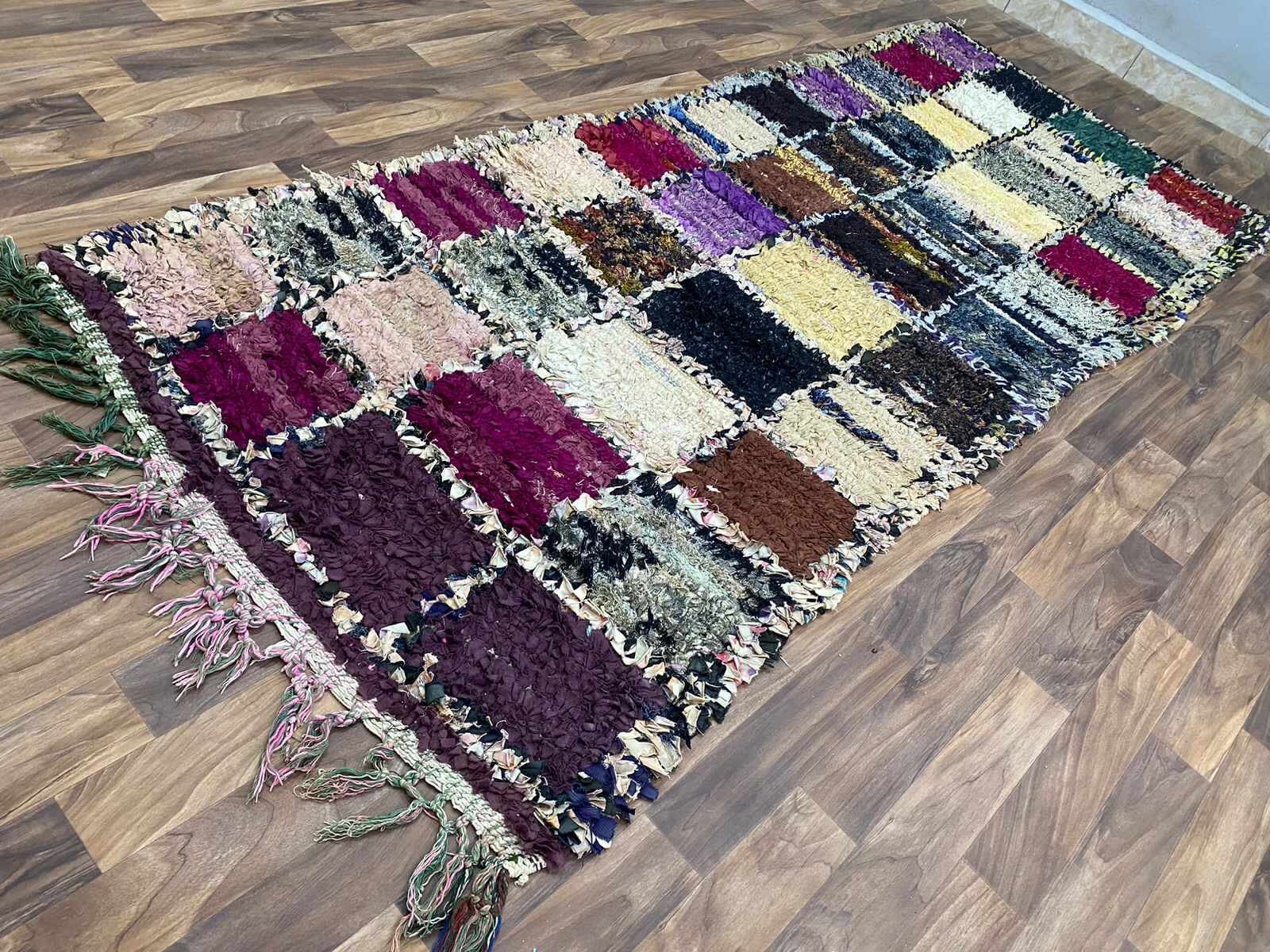 Colorful patchwork area rug with fringes, perfect for enhancing home decor.