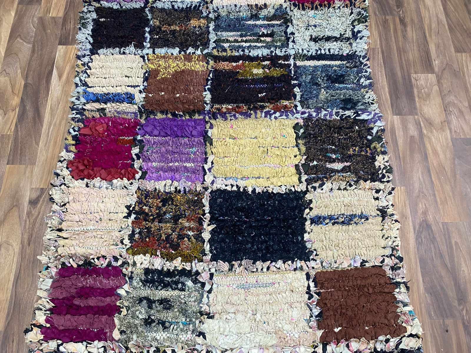 Colorful rag rug with various textures and patterns, perfect for enhancing home decor.