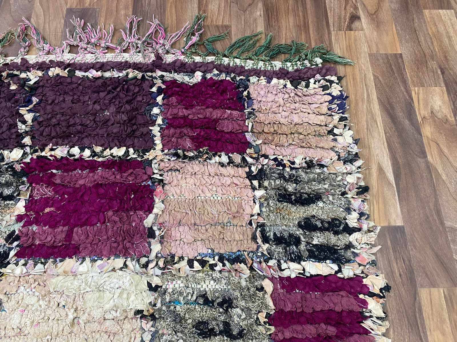 Colorful handmade rag rug with fringes, perfect for adding texture to your decor.