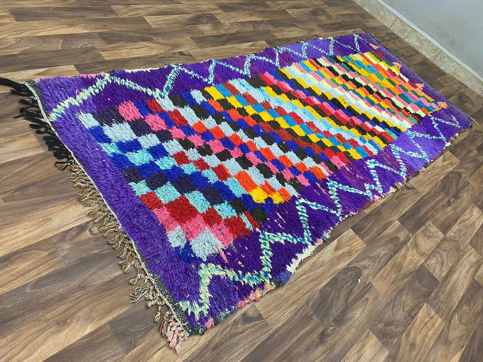 Colorful handmade rug with intricate patterns, perfect for home decor and style enhancement.